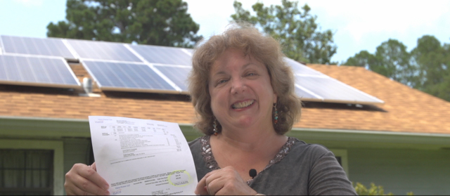 Margie showing off one of her utility bills.